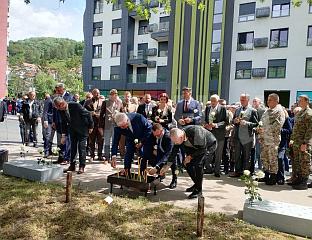INCENSE, ROSES AND CANDLES AT THE SITE OF MURDER OF 54 YOUNG MEN